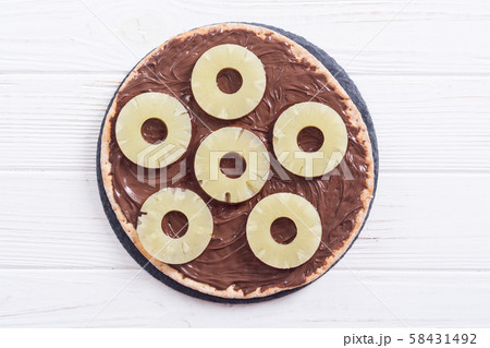 Fruit pizza with nut nougat cream and pineapple 58431492