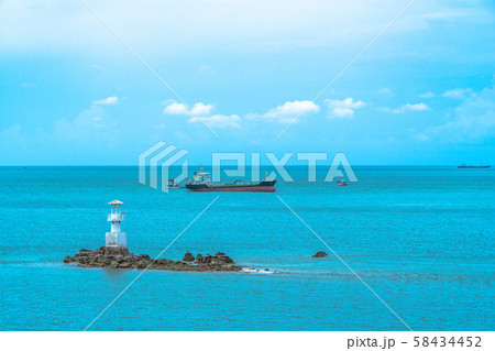 cargo boats moored near the lighthouse 58434452