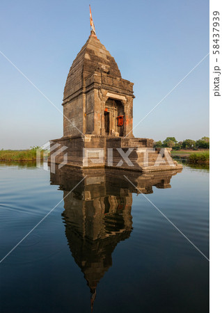 Small Hindu temple in the middle of the holy Narmada River, Maheshwar, Madhya Pradesh state, India Small Hindu temple in the middle of the holy Narmada River, Maheshwar, Madhya Pradesh state, India 58437939
