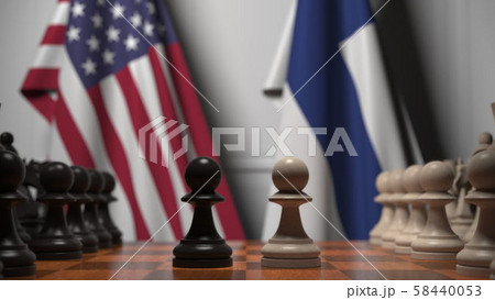 Flags of USA and Finland behind pawns on the chessboard. Chess game or political rivalry related 3D 58440053