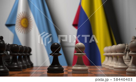 Flags of Argentina and Colombia behind pawns on the chessboard. Chess game or political rivalry 58440403