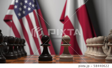 Flags of USA and Denmark behind pawns on the chessboard. Chess game or political rivalry related 3D Flags of USA and Denmark behind pawns on the chessboard. Chess game or political rivalry related 3D 58440622