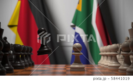 Flags of Germany and South Africa behind pawns on the chessboard. Chess game or political rivalry 58441019