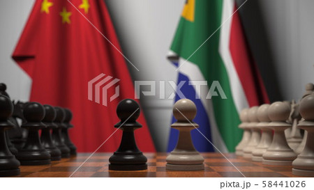 Flags of China and South Africa behind pawns on the chessboard. Chess game or political rivalry Flags of China and South Africa behind pawns on the chessboard. Chess game or political rivalry 58441026