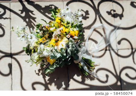 Wedding bouquet from beautiful flowers: pink roses, white and pink ranunculus 58450074