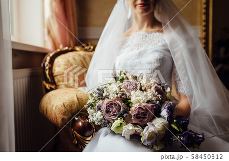 Beautiful bride is holding a wedding colorful bouquet. Beautiful bride is holding a wedding colorful bouquet. 58450312