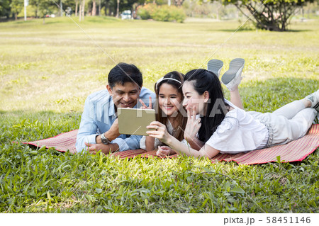 Parents and children are playing the tablet on the Parents and children are playing the tablet on the 58451146