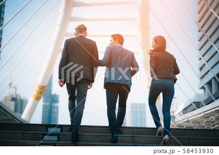 Rear view of business team climbing stairs go to a Rear view of business team climbing stairs go to a 58453930