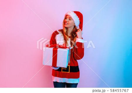 Pensive dreaming girl in Santa hat with Christmas 58455767
