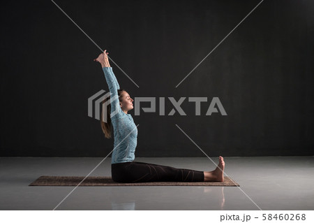 Woman working out a doing yoga or pilates exercise in Dandasana Woman working out a doing yoga or pilates exercise in Dandasana 58460268