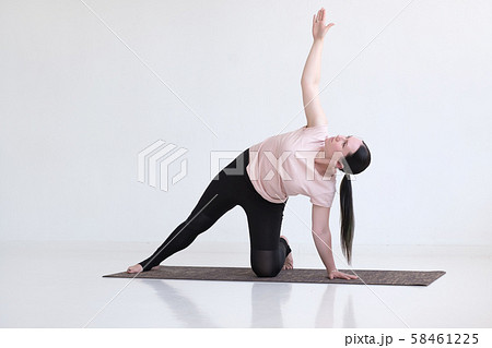 woman doing Side Plank Posture, Pose of Vashista, Vasisthasana 58461225