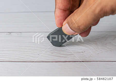 Eraser and error concept, Hand with black eraser Eraser and error concept, Hand with black eraser 58462107