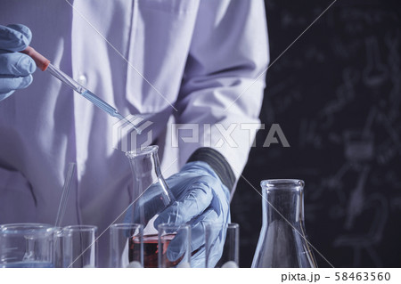 Researcher with glass laboratory chemical test Researcher with glass laboratory chemical test 58463560