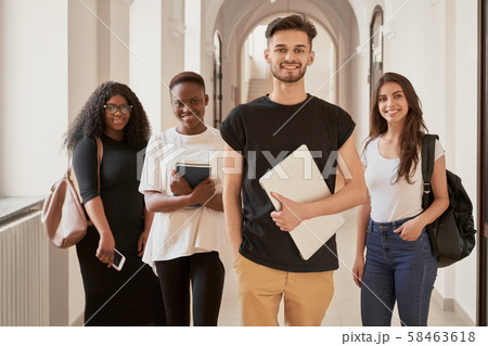 Multiracial group of students smiling and looking at camera Multiracial group of students smiling and looking at camera 58463618