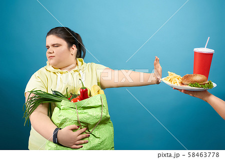 Chunky brunette girl refusing fastfood on her life 58463778