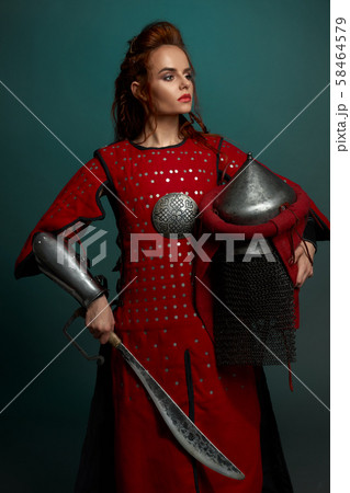 Barbarian female fighter posing with helmet and knife 58464579