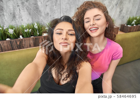 View from above of funny girls doing selfie in cafe 58464695
