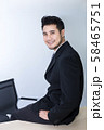 Young handsome businessman smiling and smart sit 58465751