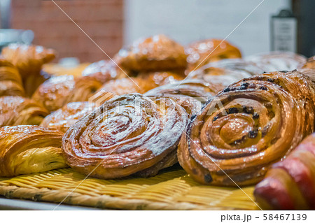 Assortment of freshly baked sweet pastry for sale on counter of french bakery Assortment of freshly baked sweet pastry for sale on counter of french bakery 58467139