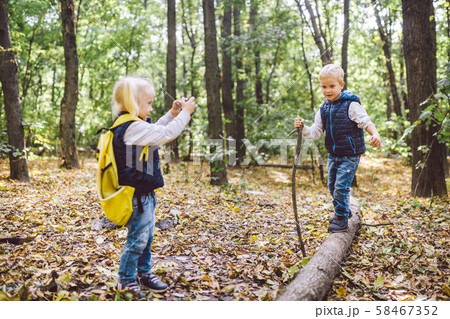 Children preschoolers Caucasian brother and sister take pictures of each other on mobile phone 58467352