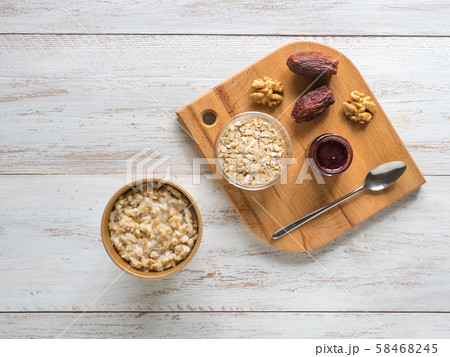 Oatmeal porridge with dates in a cardboard cup.  58468245