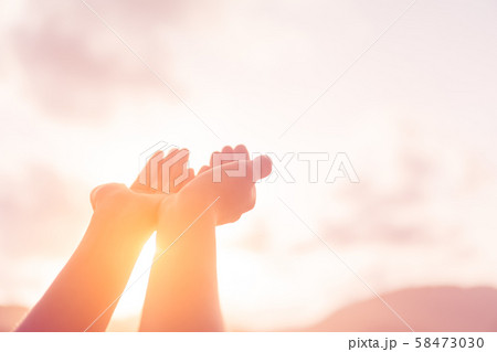 Woman hands place together like praying in front Woman hands place together like praying in front 58473030