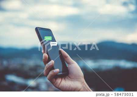 Women hand using smartphone typing, chatting 58473031