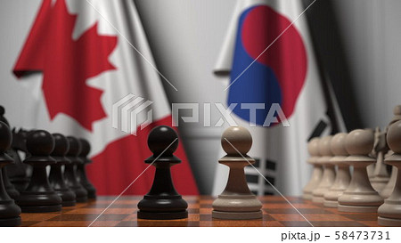 Chess game against flags of Canada and Korea. Political competition related 3D rendering 58473731