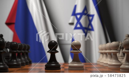 Flags of Russia and Israel behind pawns on the chessboard. Chess game or political rivalry related Flags of Russia and Israel behind pawns on the chessboard. Chess game or political rivalry related 58473825