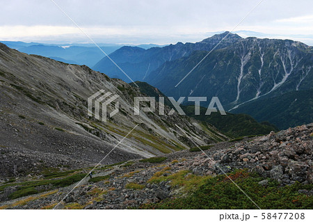 北アルプス 槍穂高縦走路 中岳山頂からの風景 笠ヶ岳と白山遠景の写真素材