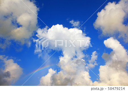 Blue sky with clouds and a rainbow. Natural background concept. 58479214