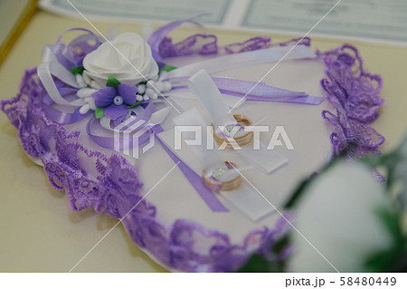 Wedding rings on a white pad. Wedding attributes 58480449