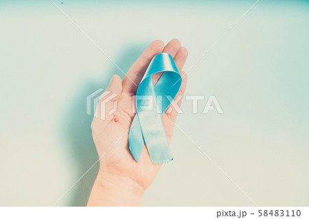 Hand holding Diabetes Awareness Blue Ribbon 58483110