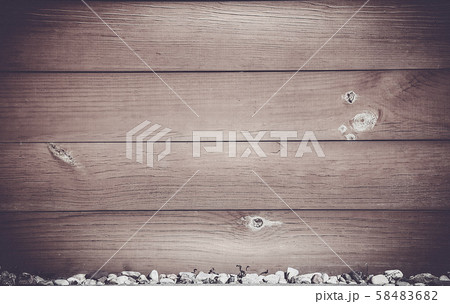 Horizontal wooden Board dark brown with bitches on the surface and small stones at the bottom 58483682