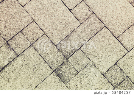 The sidewalk road made of natural stone is lined with mosaics of light gray color The sidewalk road made of natural stone is lined with mosaics of light gray color 58484257