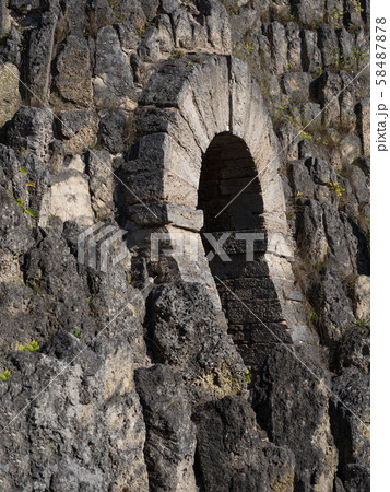 Tunnel into the cave through the mountain. 58487878