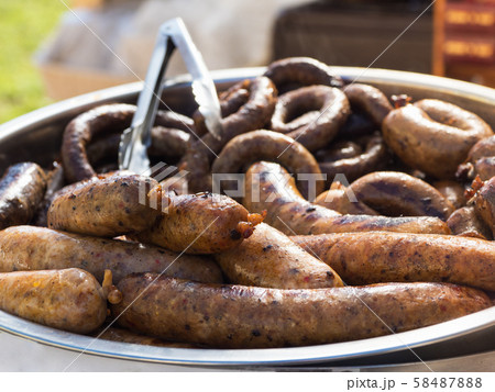 Grilled boar sausages on a large platter 58487888