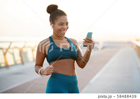 Dark-eyed woman feeling satisfied after reaching target weight Dark-eyed woman feeling satisfied after reaching target weight 58488439