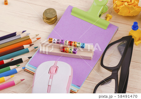 cube with word MARKETING PLAN on wooden desk 58491470