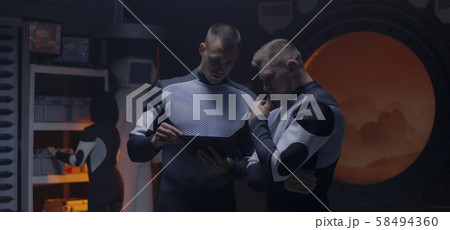 Astronauts working in a Mars base Astronauts working in a Mars base 58494360