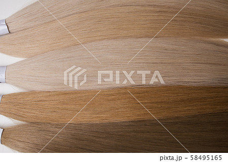 Hair of different shades. Close-up on a white background. Hair of different shades. Close-up on a white background. 58495165