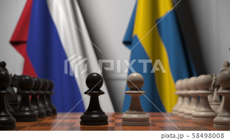 Flags of Russia and Sweden behind pawns on the chessboard. Chess game or political rivalry related Flags of Russia and Sweden behind pawns on the chessboard. Chess game or political rivalry related 58498008