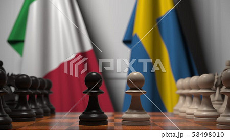 Flags of Italy and Sweden behind pawns on the chessboard. Chess game or political rivalry related 3D Flags of Italy and Sweden behind pawns on the chessboard. Chess game or political rivalry related 3D 58498010