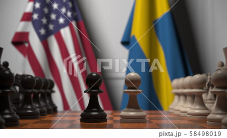 Flags of USA and Sweden behind pawns on the chessboard. Chess game or political rivalry related 3D Flags of USA and Sweden behind pawns on the chessboard. Chess game or political rivalry related 3D 58498019