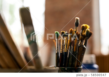 Group of various paintbrushes for professional painting on workplace of artist Group of various paintbrushes for professional painting on workplace of artist 58500547