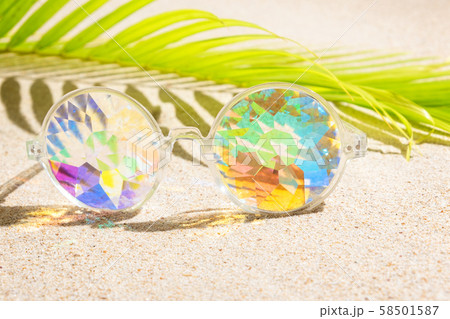 Funny kaleidoscope multicolour glasses on sand Funny kaleidoscope multicolour glasses on sand 58501587