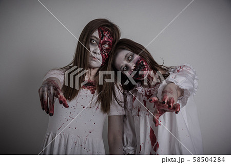 Scary two asian female zombie standing over gray and dark background 58504284