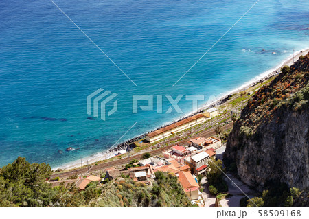 Aerial breathtaking view of Giardini Naxos railway station, shore of Ionian sea 58509168
