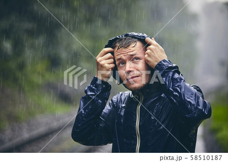 Traveler in heavy rain 58510187