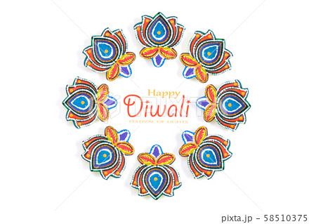 Happy Diwali - Clay Diya lamps lit during Dipavali, Hindu festival of lights celebration. Colorful traditional oil lamp diya on white background. Copy space for text. Happy Diwali - Clay Diya lamps lit during Dipavali, Hindu festival of lights celebration. Colorful traditional oil lamp diya on white background. Copy space for text. 58510375